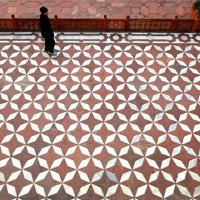 The lower platform with red sand stone and marble design at the Taj Mahal in Agra. The Taj Mahal has many interesting patterns used in the flooring in its exterior as well as in the interior of its buildings.