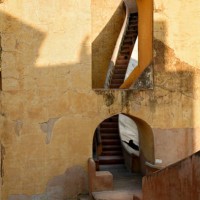 The steps in this photograph lead to the quadrants of Brahat Samrat Yantra, the world’s largest sundial. Jaipur’s founder and astronomer, Sawai Jai Singh, constructed this sundial in 1724. It is the largest astronomical instrument in the Yantra Shala (Astronomical Observatory) that includes 16 instruments that continue to function.